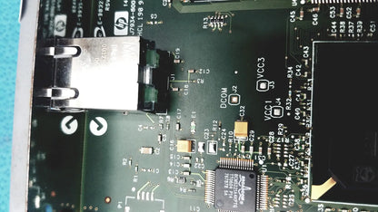Black HP Jetdirect 620N motherboard with silver USB port and components for fast ethernet print server use