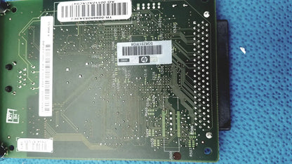 Green hp jetdirect 620n circuit board with white barcode labels and metallic solder points for fast ethernet print server
