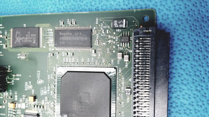 Green circuit board with black integrated circuits and large heat sink in hp jetdirect 620n fast ethernet print server