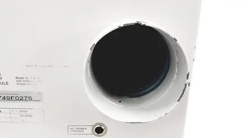 White circular speaker grille with black interior and manufacturer label on hp power module laser power output 50/60hz