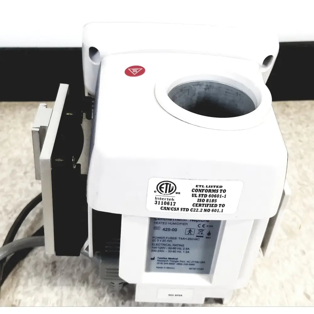 White plastic hudson rci conchatherm neptune heated humidifier with circular opening and certification labels visible