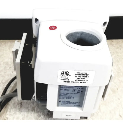 White plastic hudson rci conchatherm neptune heated humidifier with circular opening and certification labels visible