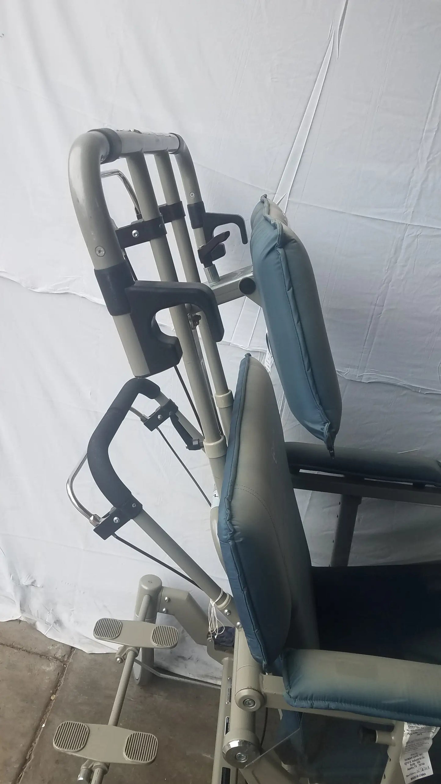 Adjustable metal leg press on humanCare I-400 bariatric convertible chair with padded blue and gray upholstery
