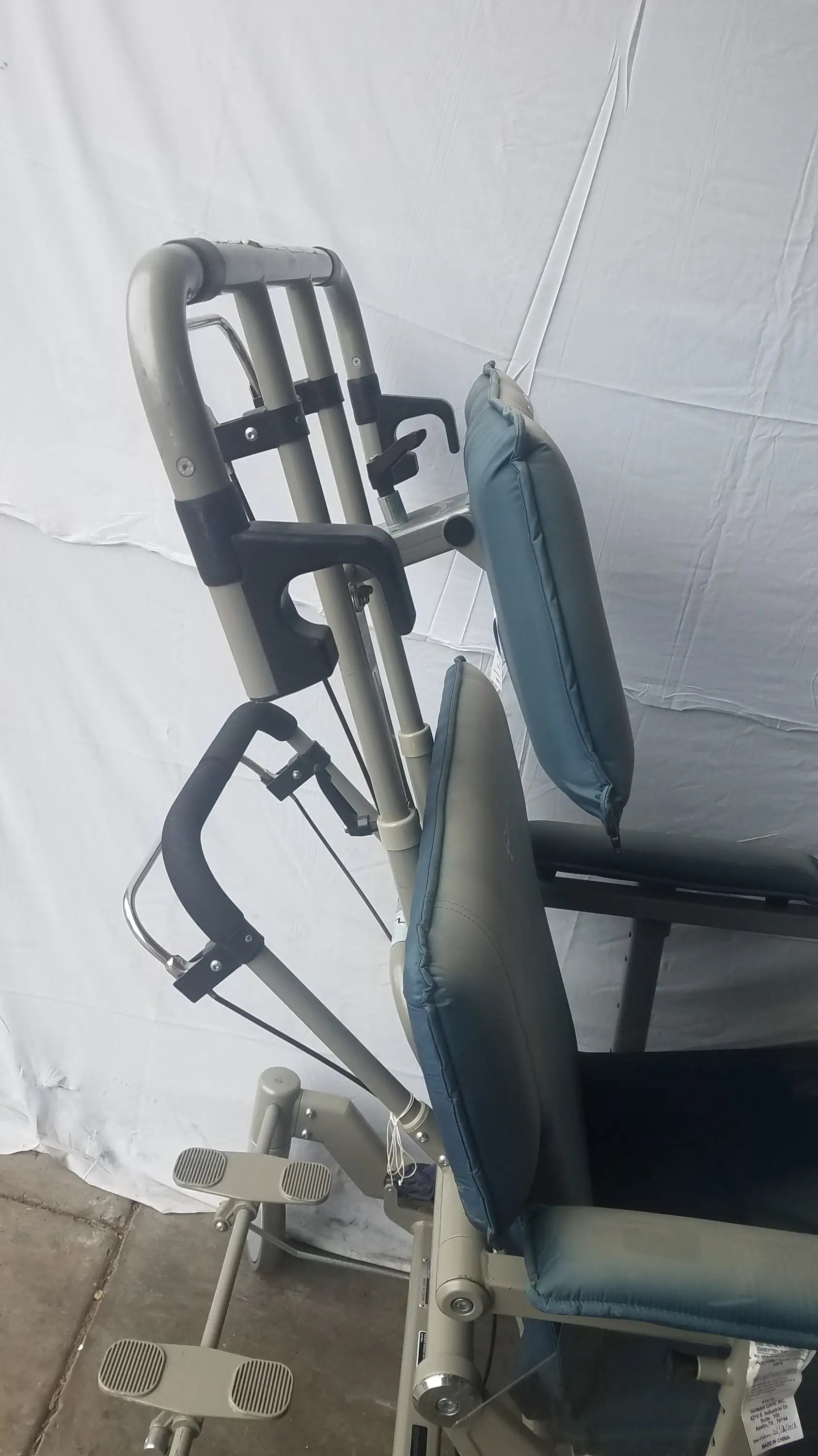 Adjustable metal leg press on humanCare I-400 bariatric convertible chair with padded blue and gray upholstery