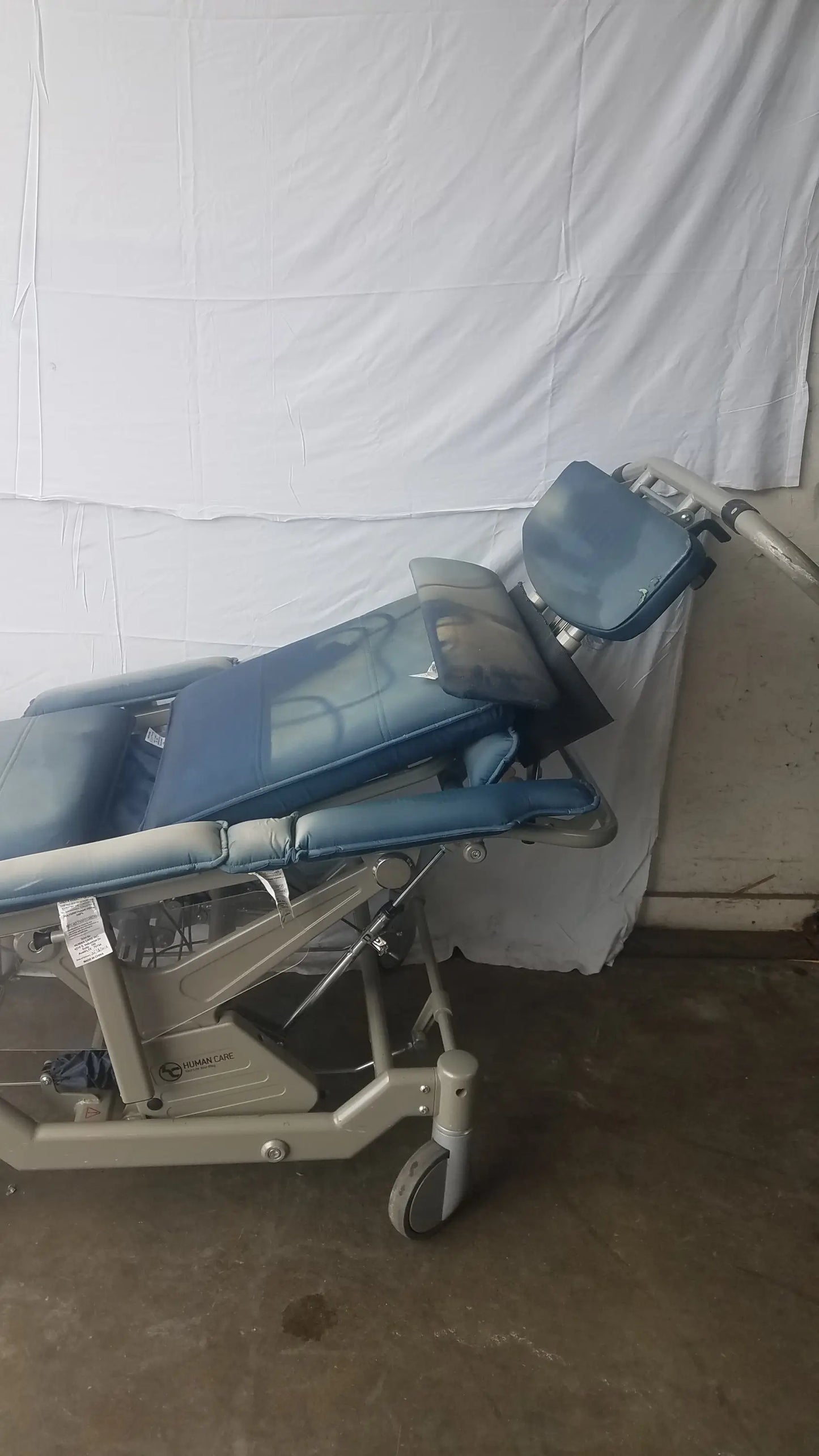 Blue padded bariatric convertible chair with adjustable sections and metal frame humanCare I-400 convertible chair