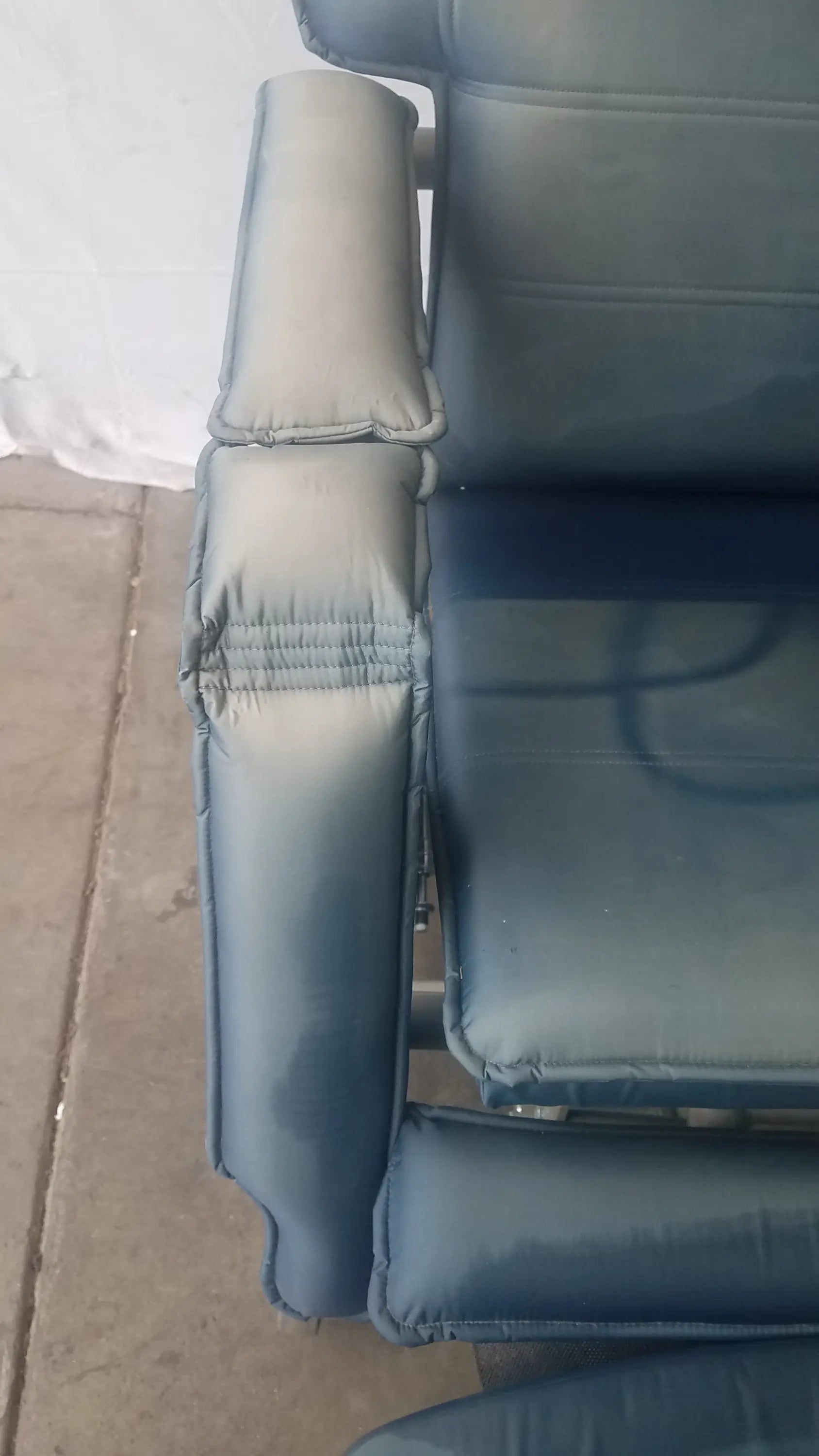 Blue padded armrest of the HumanCare I-400 bariatric convertible chair showcasing comfort and support features