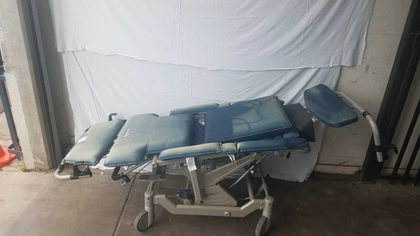 Blue padded bariatric convertible chair with adjustable sections and metal frame for medical examination use