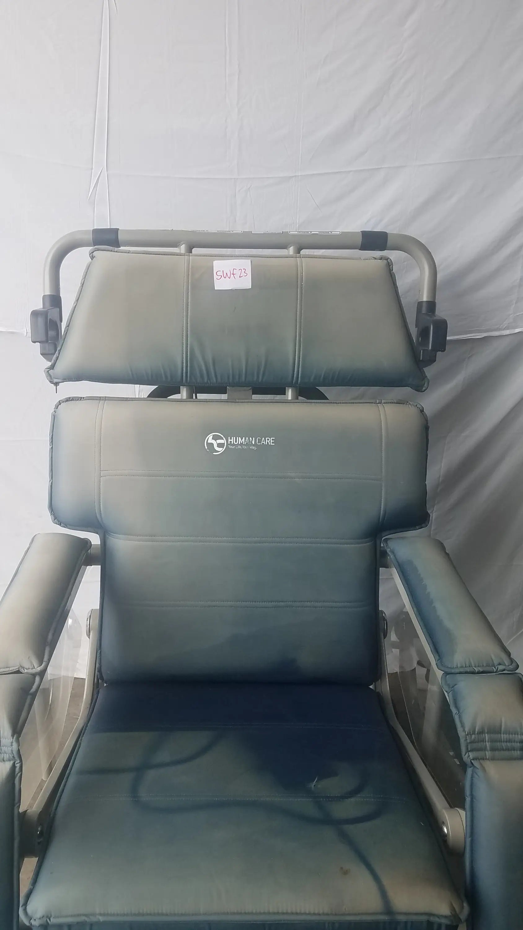 HumanCare I-400 bariatric convertible chair with gray upholstered recliner, metal frame, and headrest support