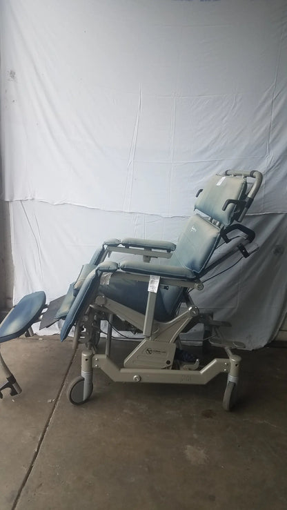 Gray adjustable humanCare I-400 bariatric convertible chair with padded upholstery and wheeled base for medical exams