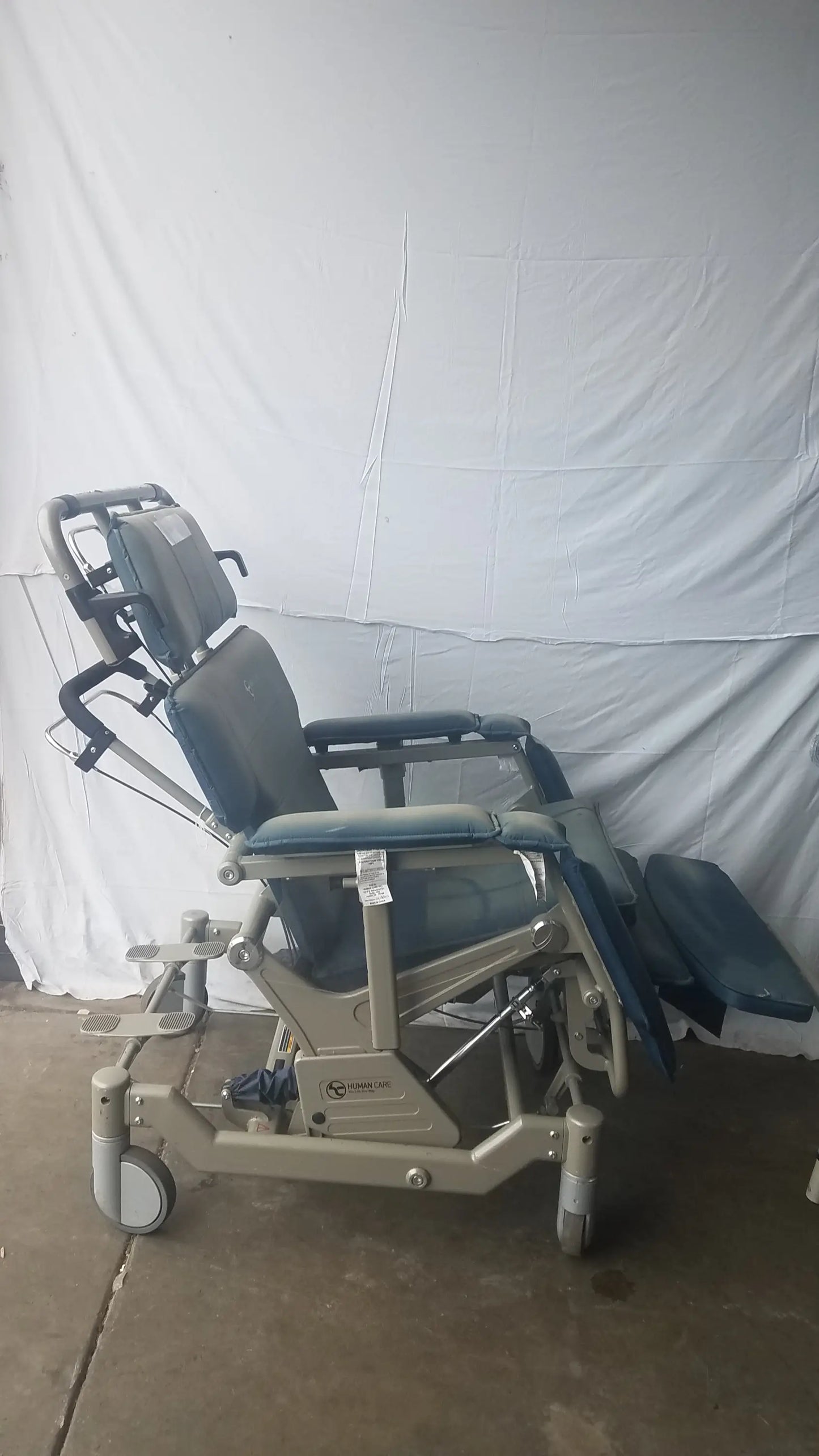 HumanCare I-400 bariatric convertible chair in gray and blue with metal frame and wheels for medical use