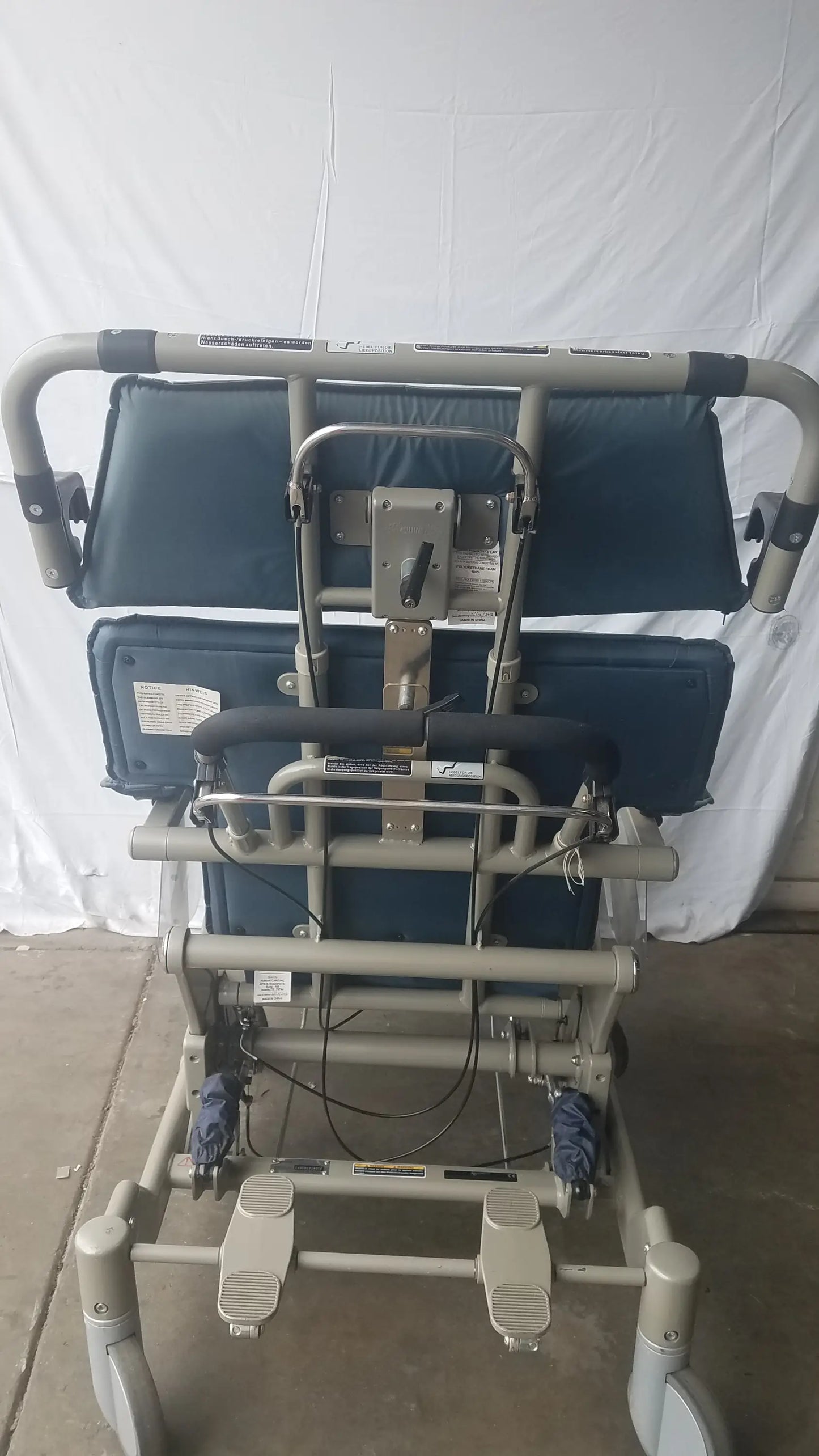 Gray metal-framed humanCare I-400 bariatric convertible chair with blue padded seat backrest and adjustable foot pedals