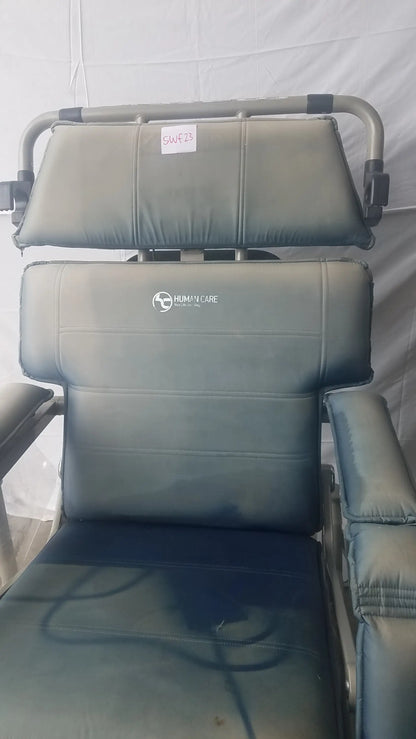 Gray upholstered bariatric convertible chair with metal frame showing human care logo on backrest rear view