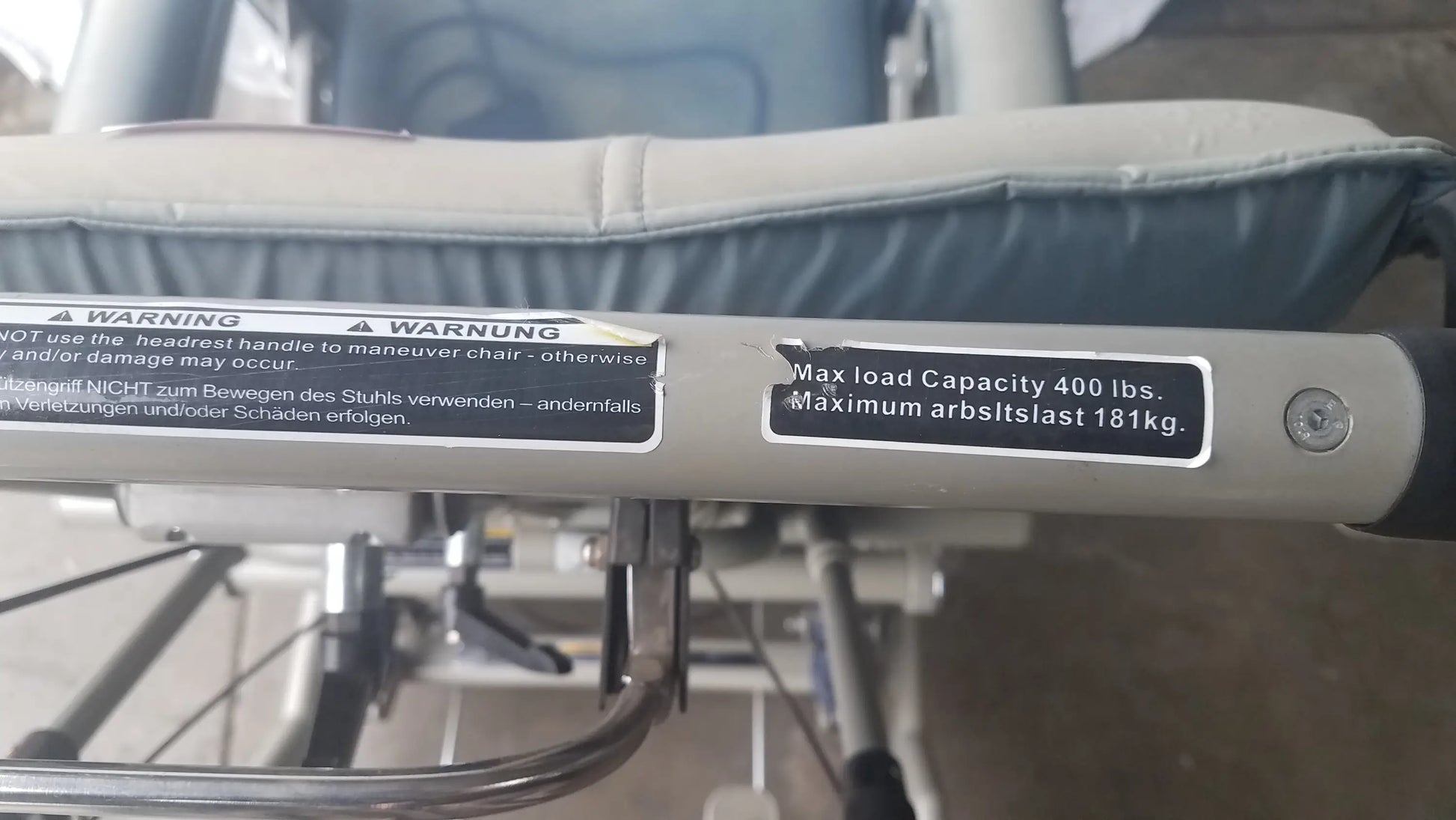 Silver metallic frame with black rubberized grip handle of humanCare i-400 bariatric convertible chair mobility scooter