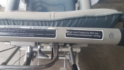 Silver metallic frame with black rubberized grip handle of humanCare i-400 bariatric convertible chair mobility scooter