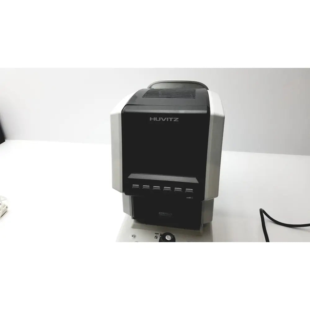 Black and silver huvitz autorefractometer keratometer desktop device with rectangular design and front control buttons