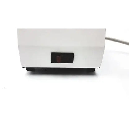 White plastic ideal products ultrasonic gel heater gw108 with a black rectangular power switch on front panel