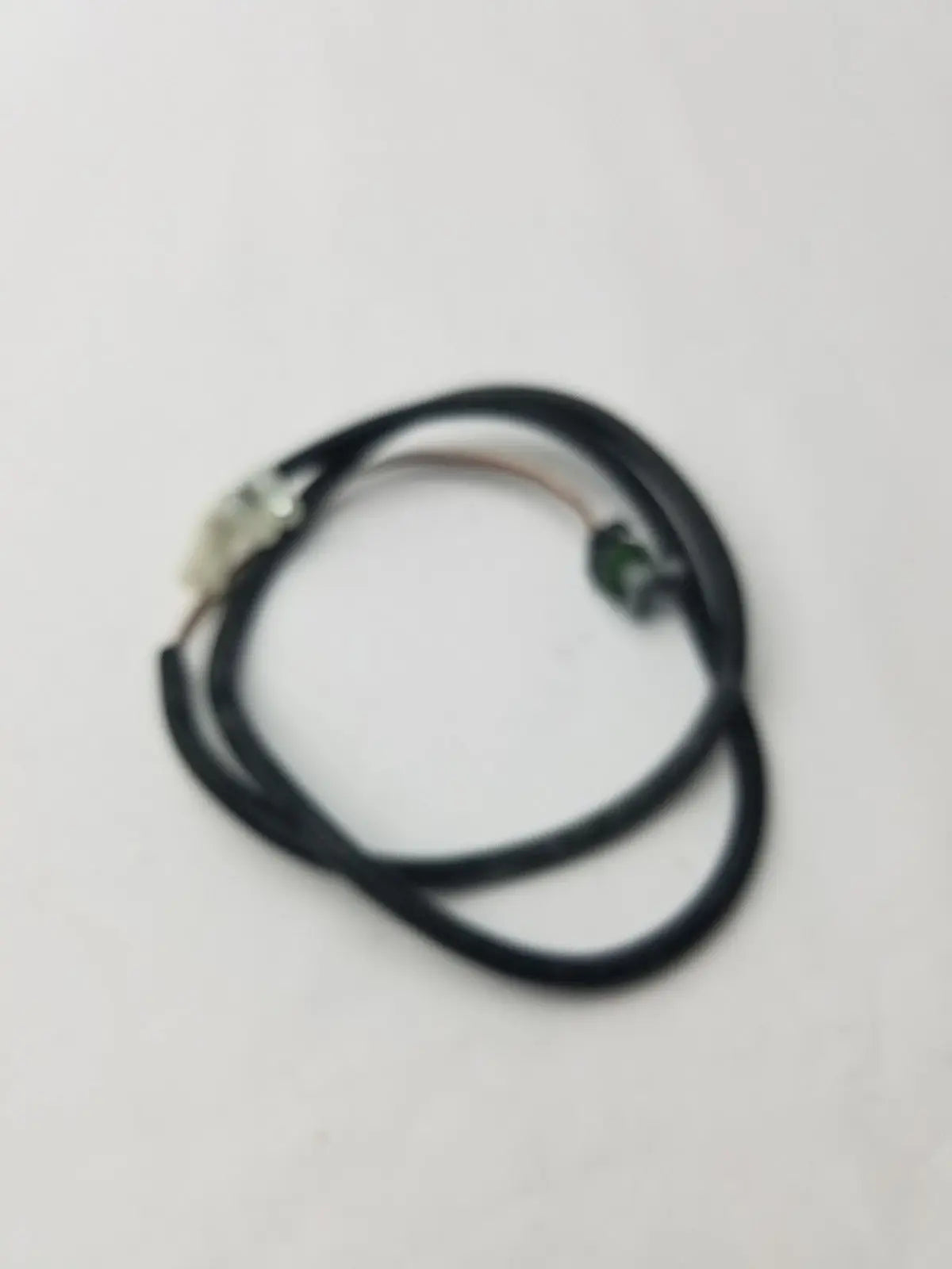 Black coiled ignition coil extension harness with metallic connectors for extending ignition coil connections