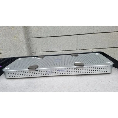 Silver metallic surgical instrument tray with perforated surface and three latches for imp innovative medical mayo knee positioner base