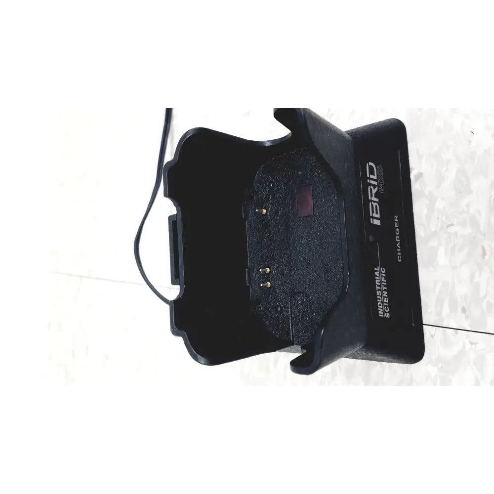 Black plastic industrial scientific mx6 ibrid charger with molded grip and textured interior for handheld use