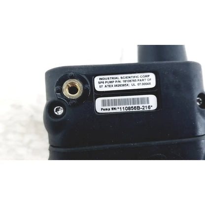 Black industrial sp6 pump with brass fittings and part number label shown with industrial scientific mx6 ibrid handheld monitor