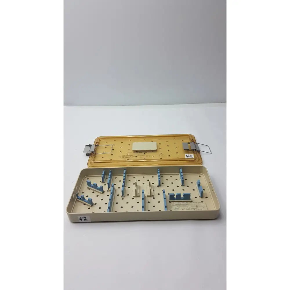 Beige and blue perforated surgical instrument tray for innovasive contack ez shoulder stabilization system empty tray