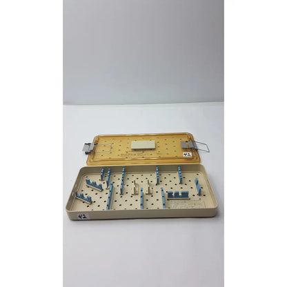 Beige and blue perforated surgical instrument tray for innovasive contack ez shoulder stabilization system empty tray