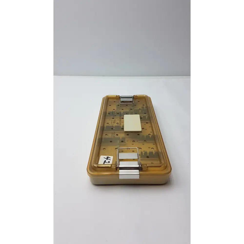 Transparent amber plastic surgical instrument case with metal clasps and label for innovasive contack ez shoulder stabilization tray