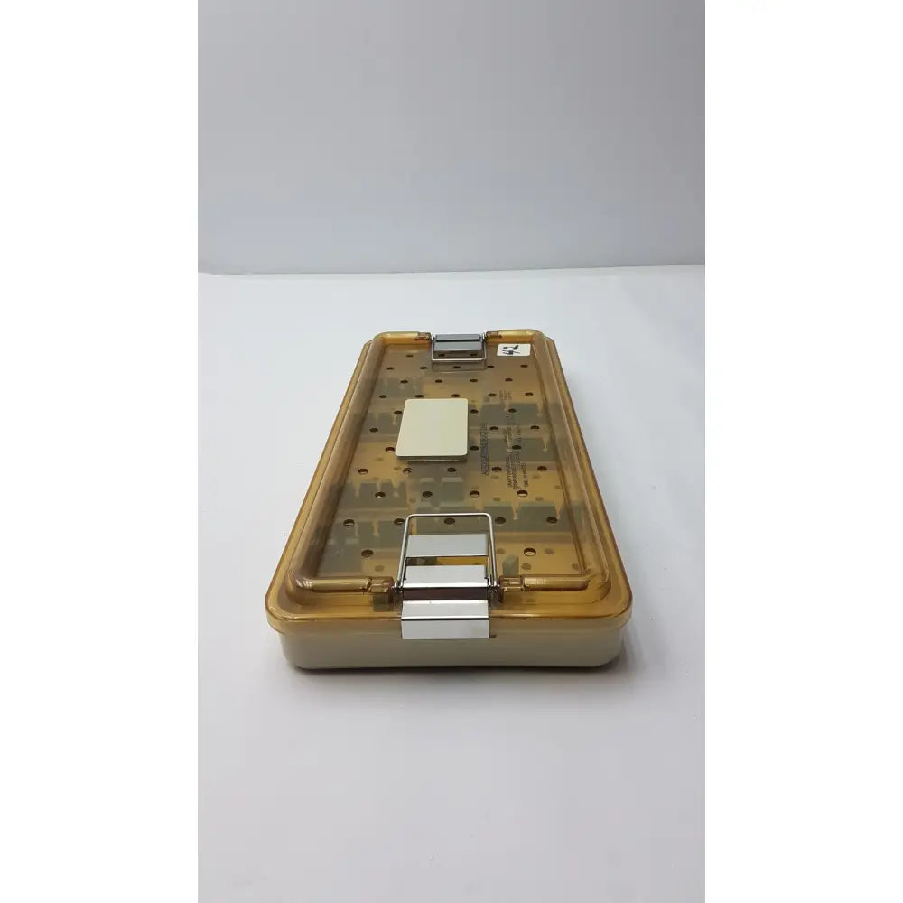 Transparent amber plastic surgical instrument tray with metallic clasp and white insert for Innovasive Contack EZ shoulder stabilization system