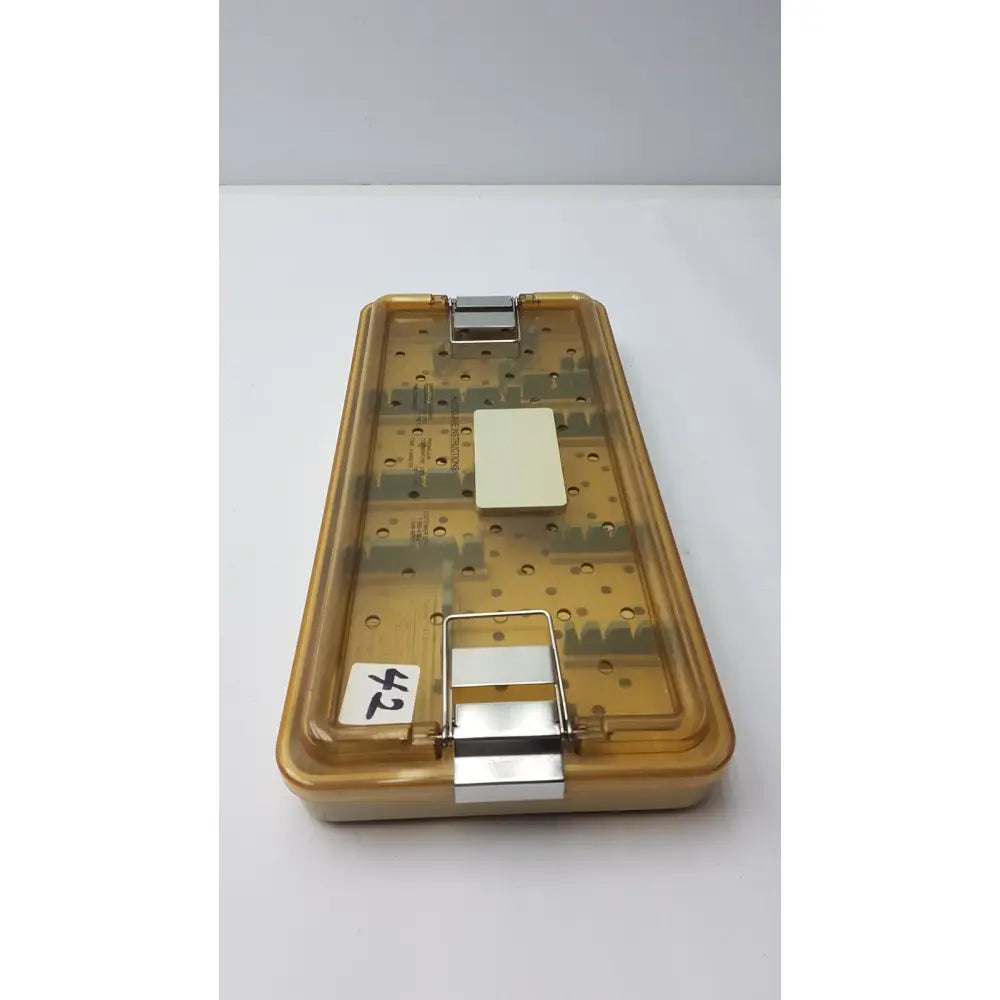 Transparent amber-colored plastic tray with metallic clasps and white insert for innovasive contack ez shoulder stabilization system