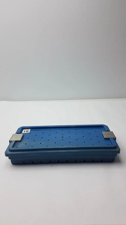Blue plastic instrument set case container with silver metal latches and perforated surface for case container sterilization