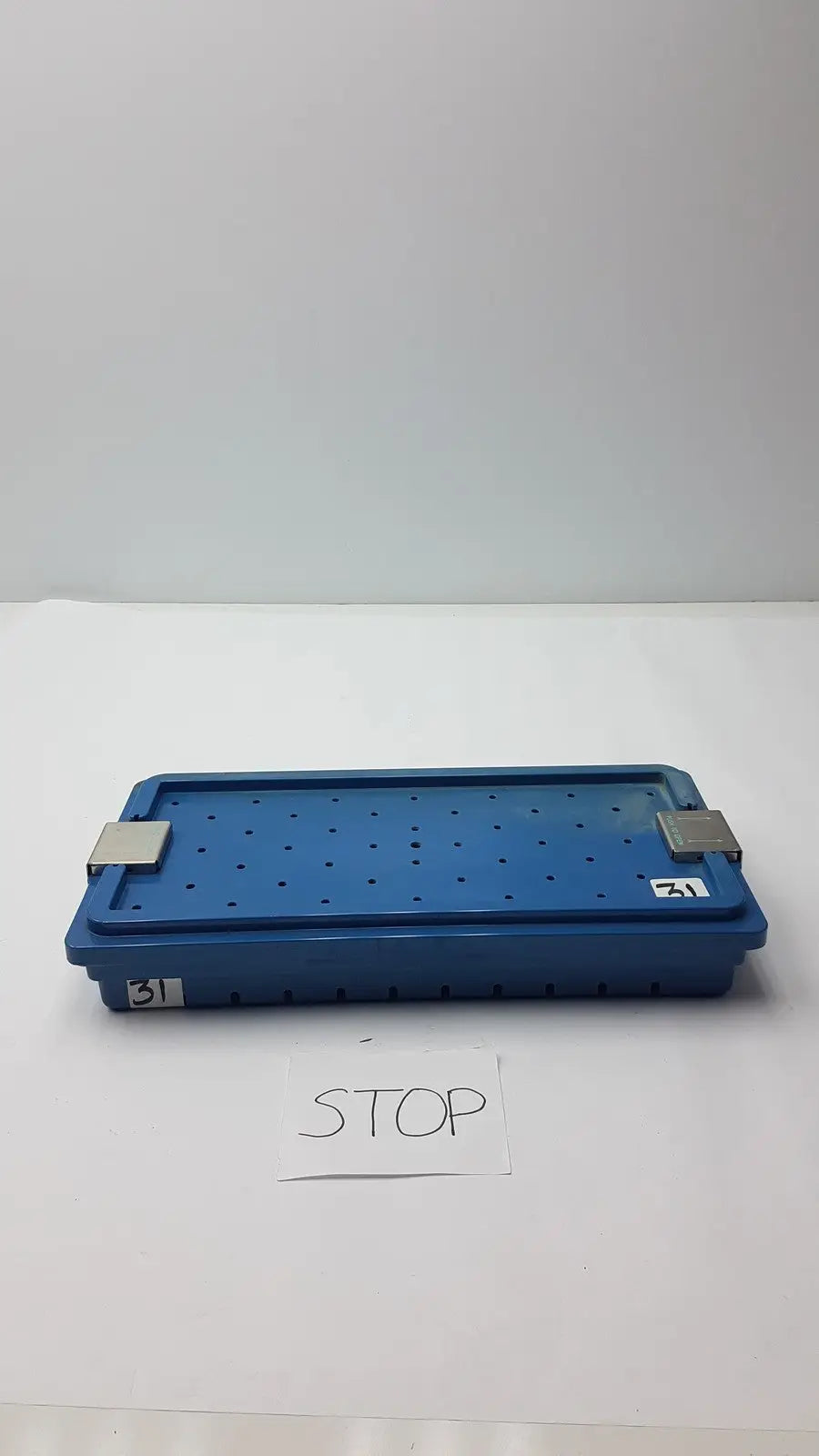 Blue plastic instrument set case with perforated surface and metallic latches for case container sterilization storage