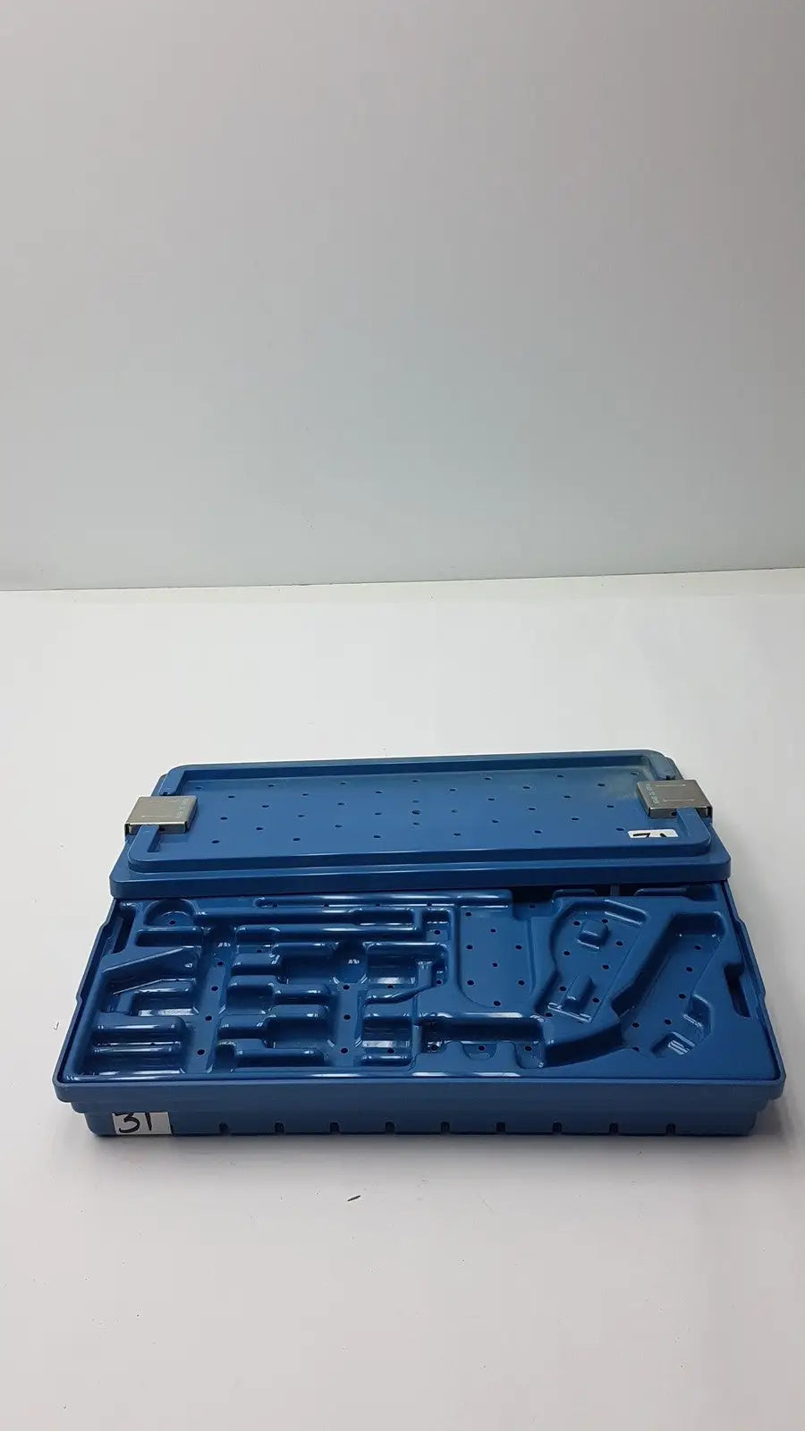 Blue plastic instrument set case container with molded compartments and metallic latches for sterilization storage tray