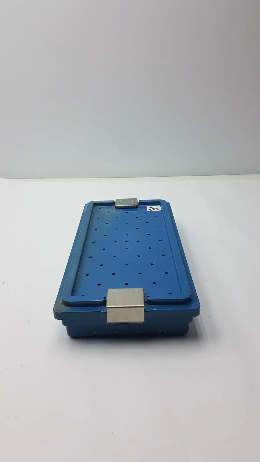 Blue plastic instrument set case container with silver metal latches and perforations for sterilization storage