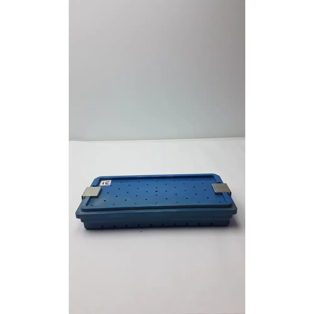 Blue plastic instrument set case container with silver metal latches and perforated surface for case container sterilization
