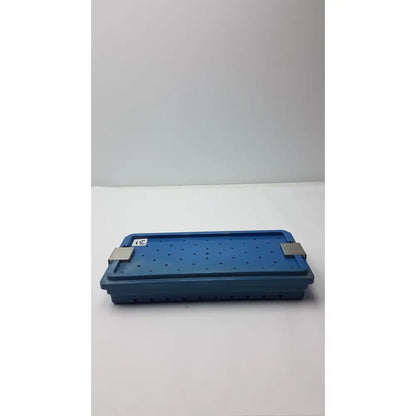 Blue plastic instrument set case container with silver metal latches and perforated surface for case container sterilization