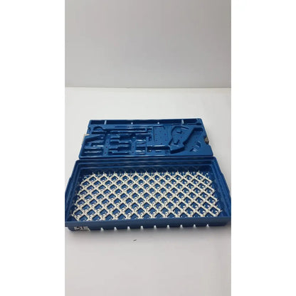 Blue plastic instrument set case with white grid-patterned interior for sterilization and storage container