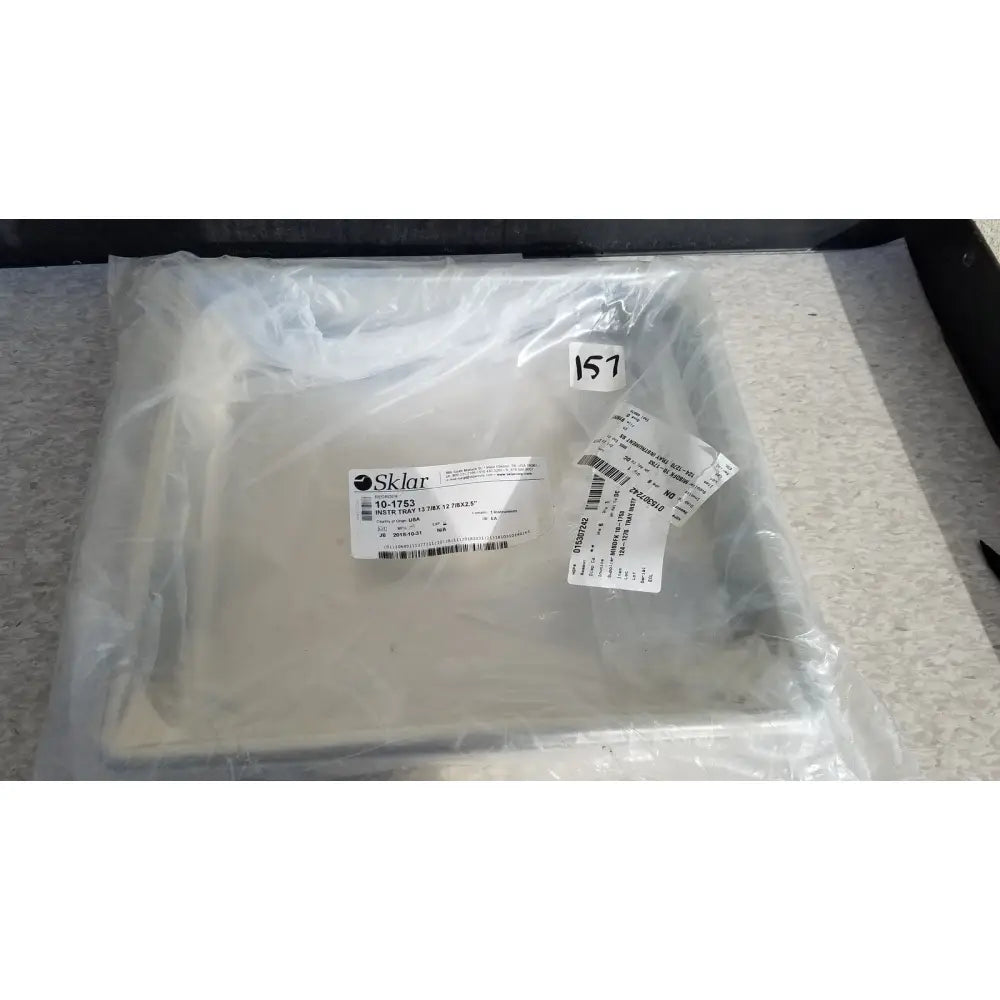 White sklar plastic instrument tray sealed in clear packaging labeled for reuse medical sterilization trays use