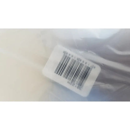 White rectangular barcode label with black lines and digits on translucent plastic instrument tray for reuse medical sterilization trays