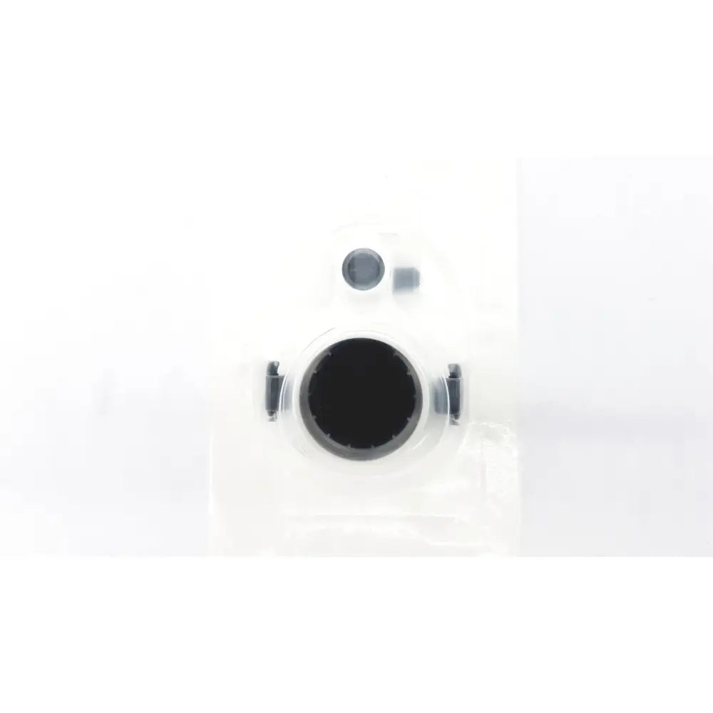 Clear plastic packaging containing a black circular intuitive da vinci xi universal seal with metallic side clips