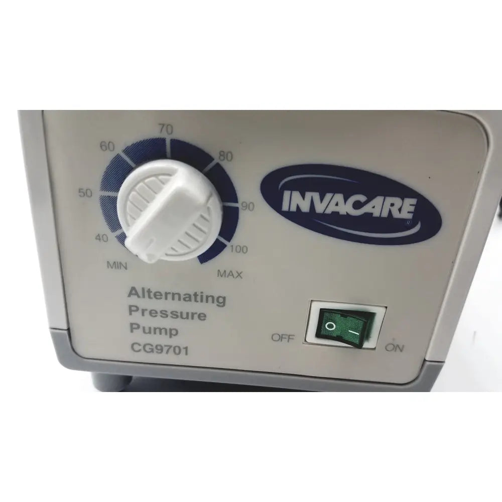 White plastic Invacare alternating pressure pump cg9701 control panel with blue dial and green switch for air mattresses