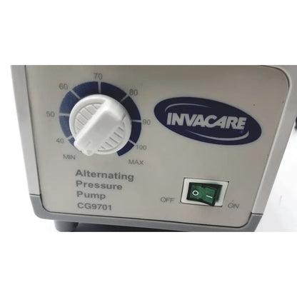 White plastic Invacare alternating pressure pump cg9701 control panel with blue dial and green switch for air mattresses