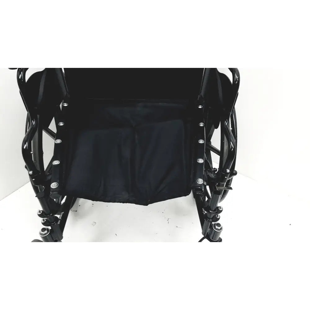 Black Invacare Tracer SX5 manual wheelchair with padded seat and metallic frame for adult standard folding use