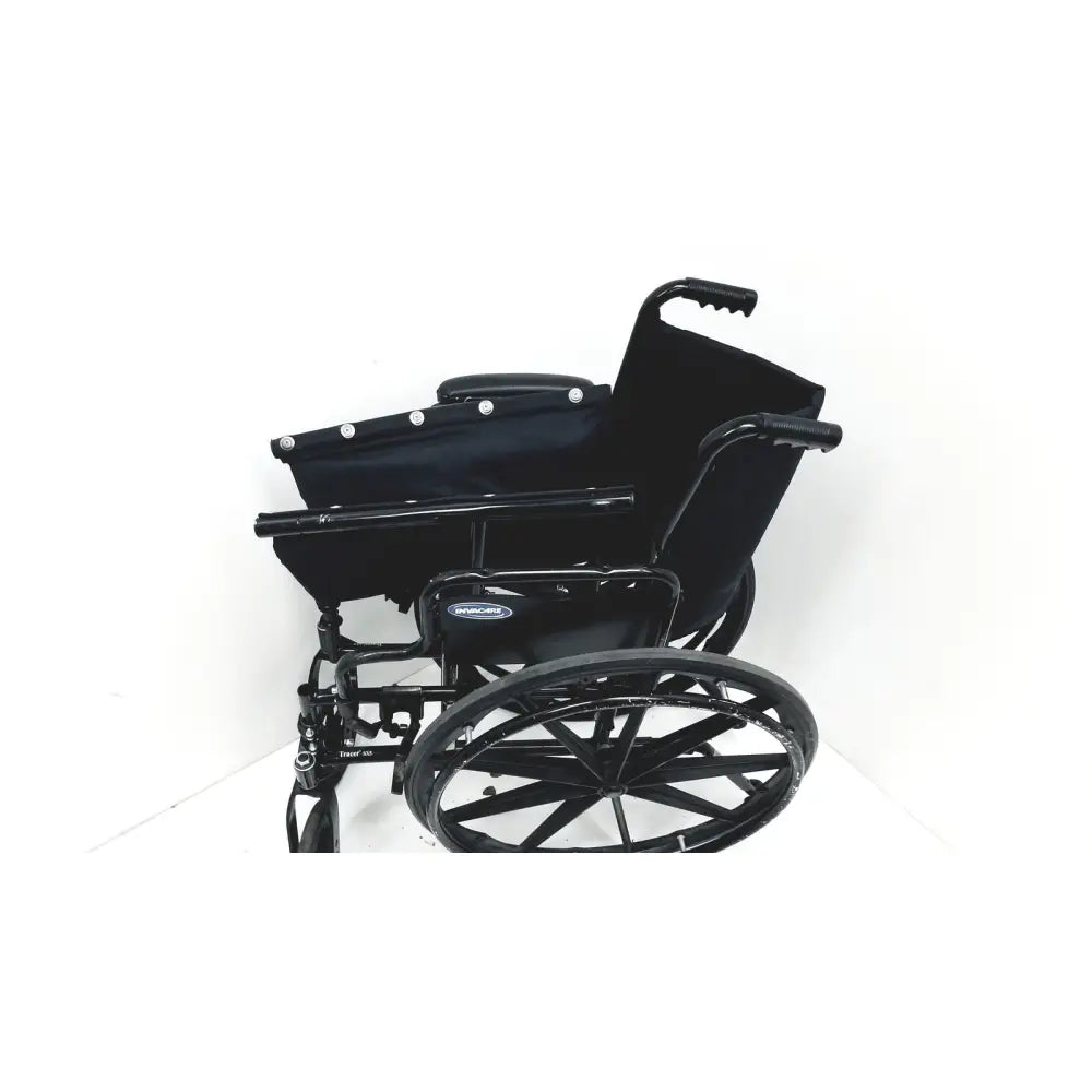 Black metal invacare tracer sx5 manual wheelchair with padded seat and backrest featuring sturdy folding design