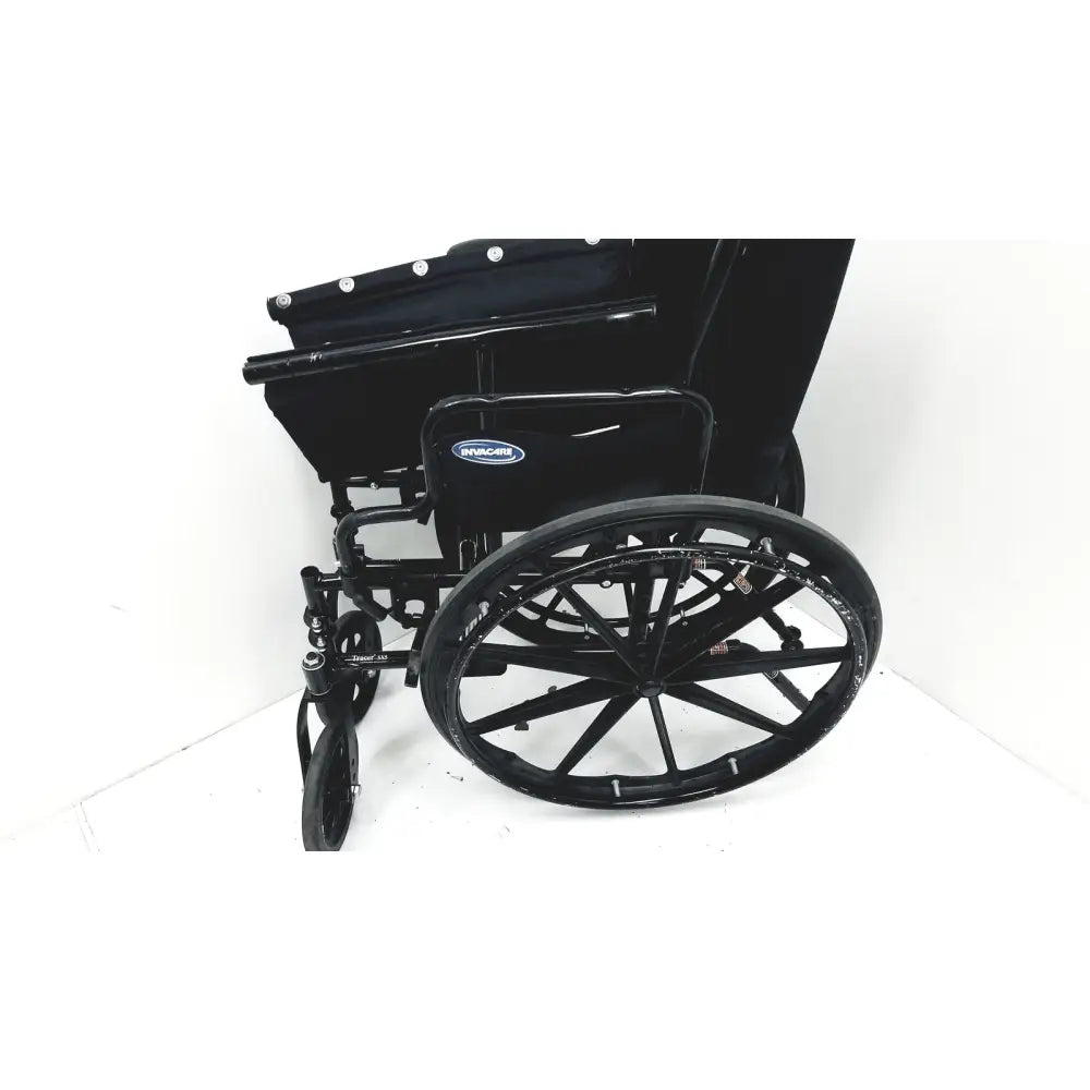 Black metal invacare tracer sx5 manual wheelchair with padded seat and backrest featuring braun logo on side
