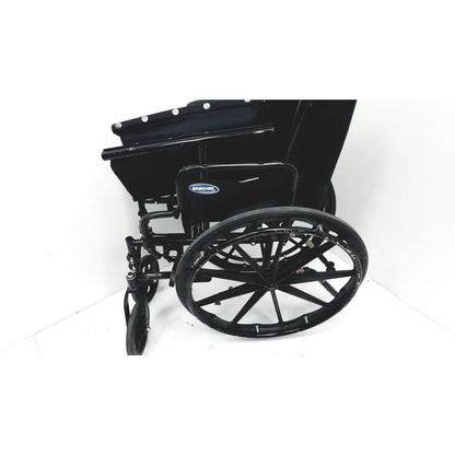 Black metal invacare tracer sx5 manual wheelchair with padded seat and backrest featuring braun logo on side