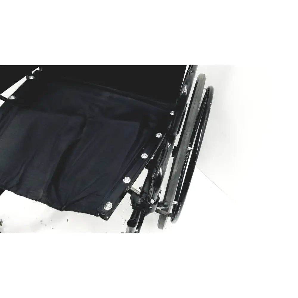Invacare tracer sx5 manual wheelchair with black fabric seat and silver rivets on black metal frame for adults standard folding