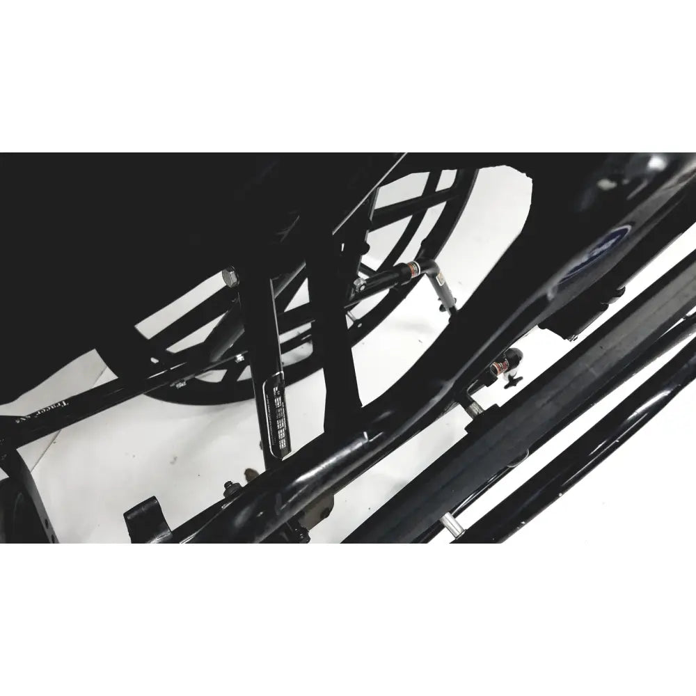 Black metal frame with visible wheel spokes of invacare tracer sx5 manual wheelchair for adults standard folding model