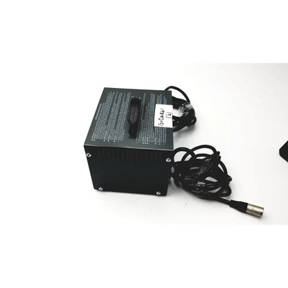 Black rectangular invacare wheelchair 24 volt automatic battery charger with coiled cables and metallic connector