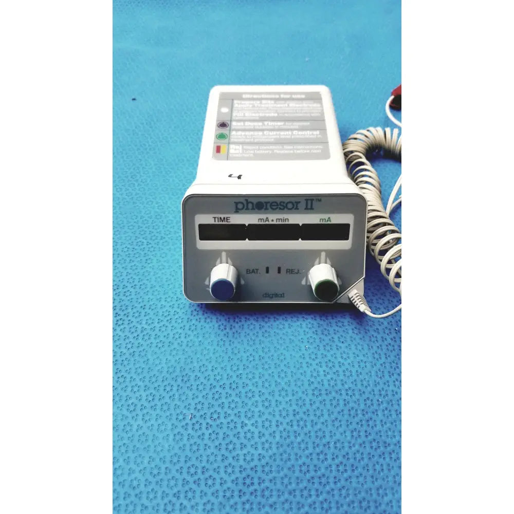 White and gray phoresor ii pm700 iontophoretic drug delivery system with two rotary knobs and labeled control panels