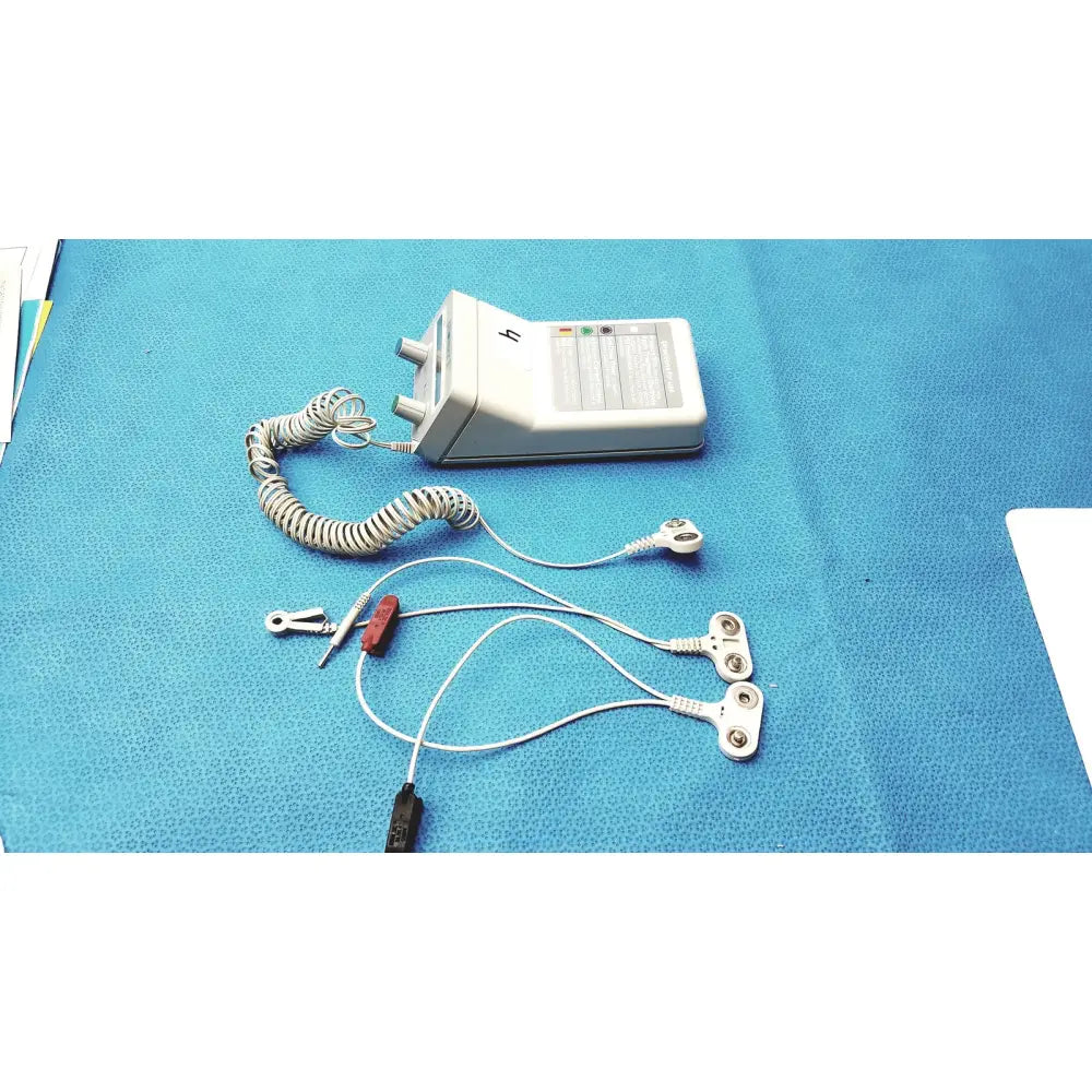White rectangular iontophoretic drug delivery device phoresor ii pm700 with coiled silver cable and multiple electrodes